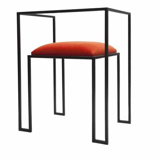 iron framed symmetrical chair with velvet coral cushion for contemporary interior design