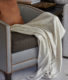 modern grey tub chair and white mini blanket accessory for luxury living room interiors from hyde park apartment project