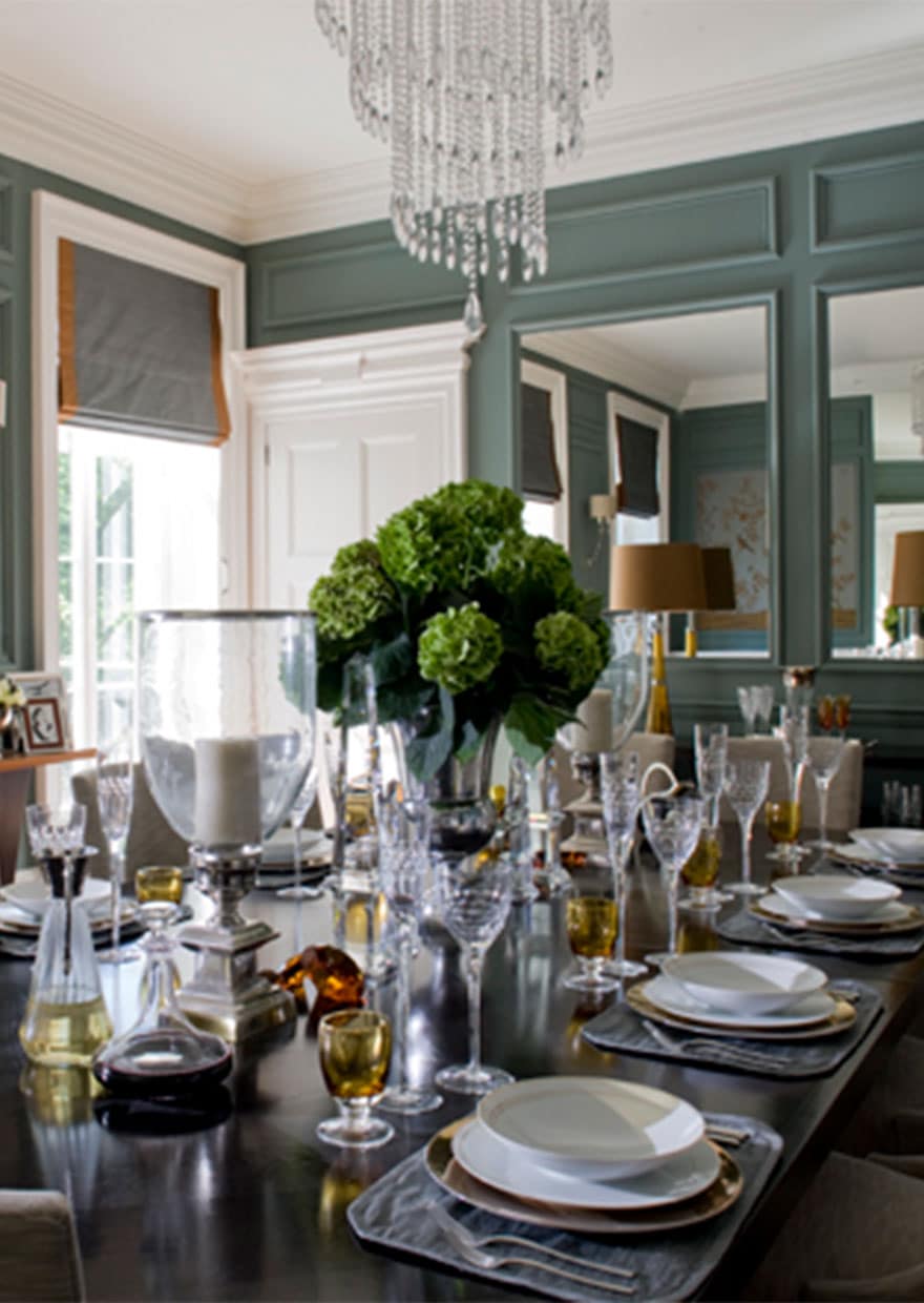 Luxury dining table with green wall panelling