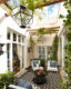 Internal courtyard with vertical plants, small armchairs and firepit.