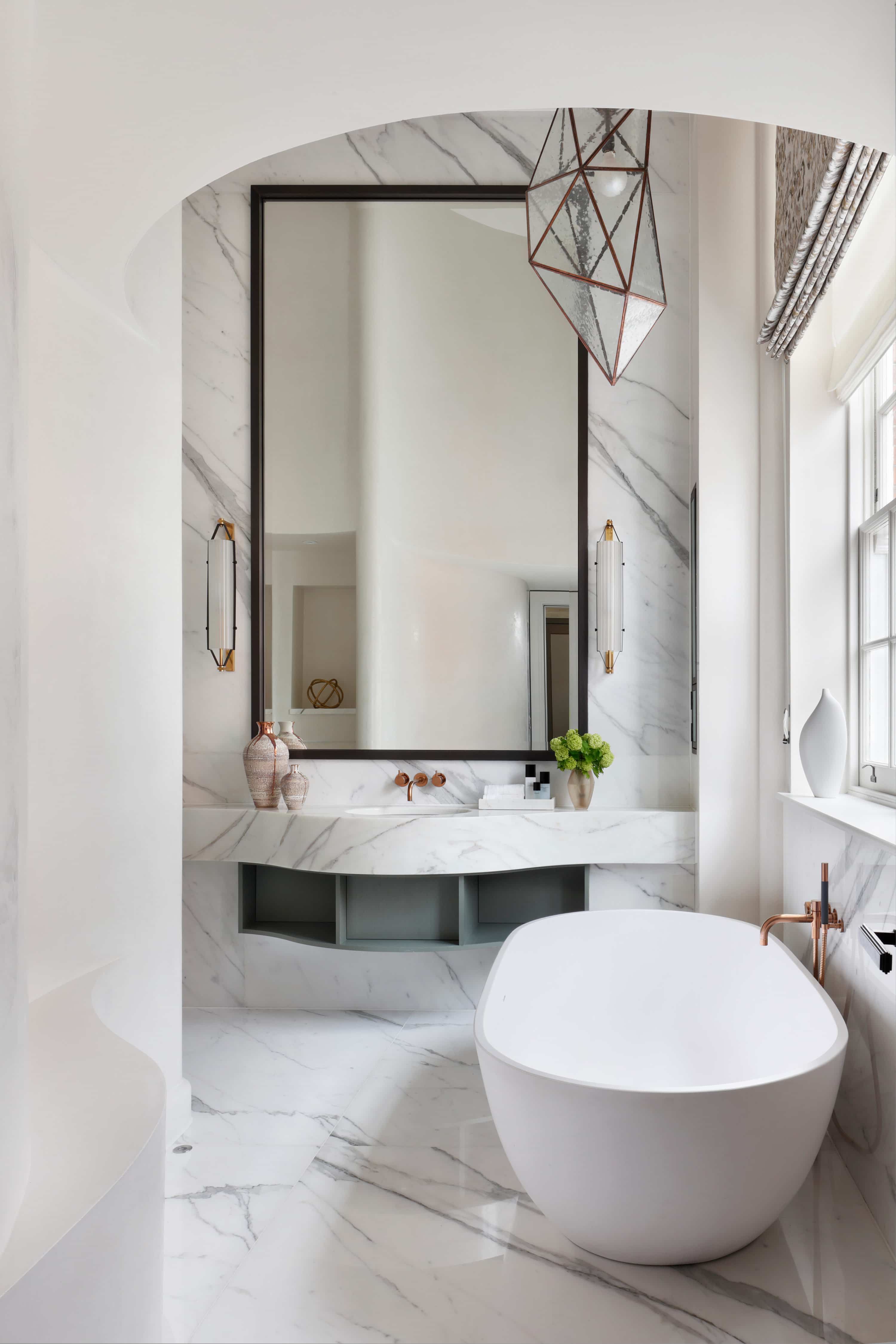 Free-standing bath and chandelier lighting in master bathroom