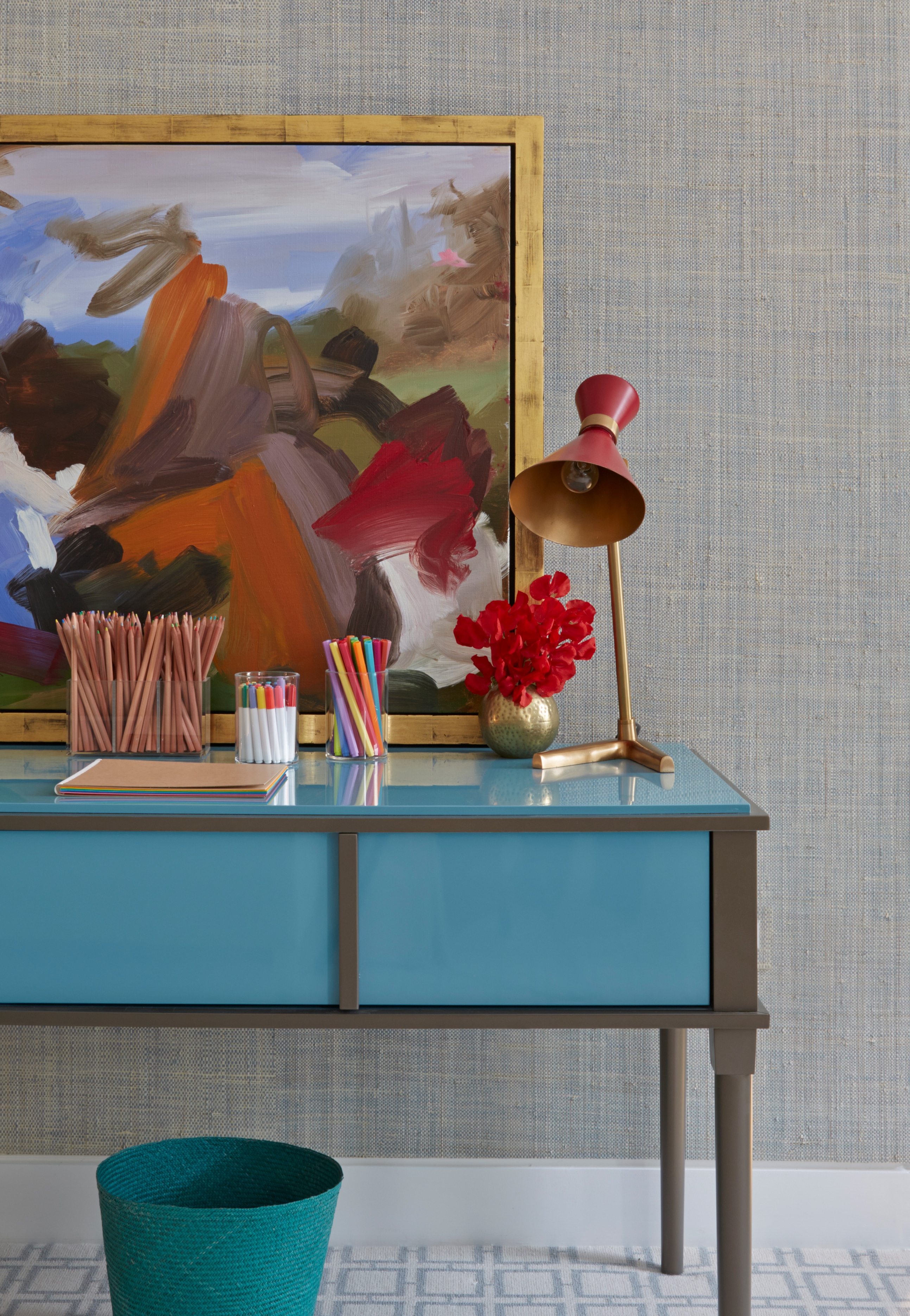 Children's blue desk with red lamp and pens